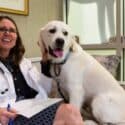 Dr. Ann Hohenhaus with a dog on a couch